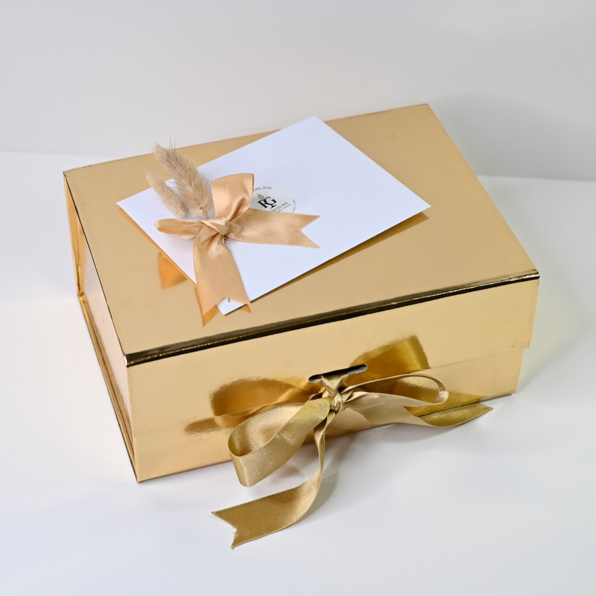 Closed large gold-finish gift box for candle gift hamper