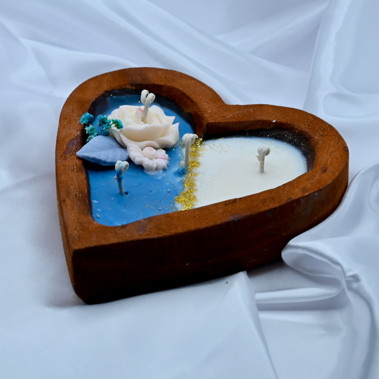 Left view of heart shaped wooden box with a decorative candle