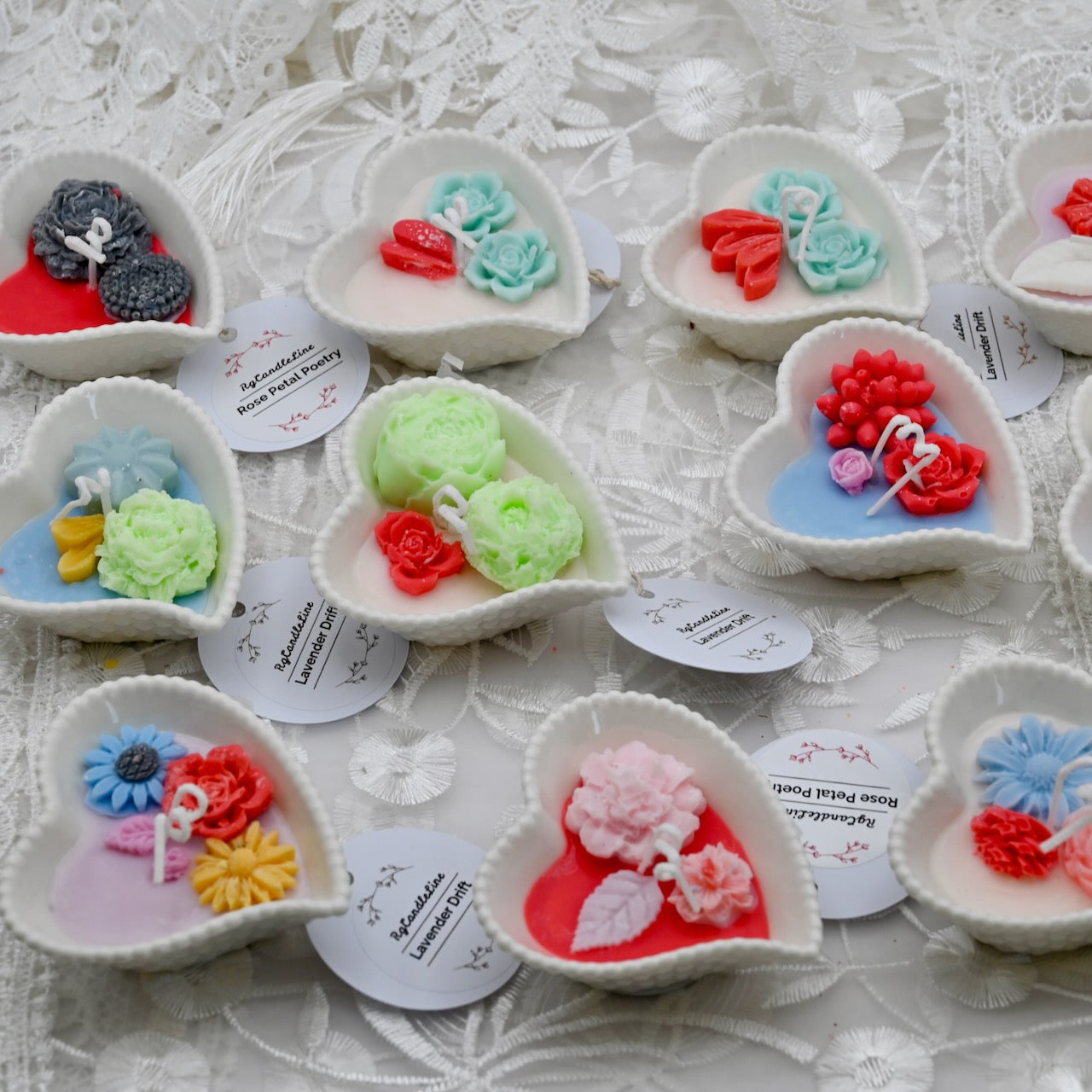 Heart-shaped ceramic items with floral designer candles on a textured surface