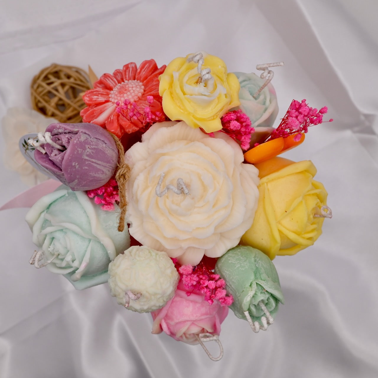 Colorful soap flower arrangement on a white background
