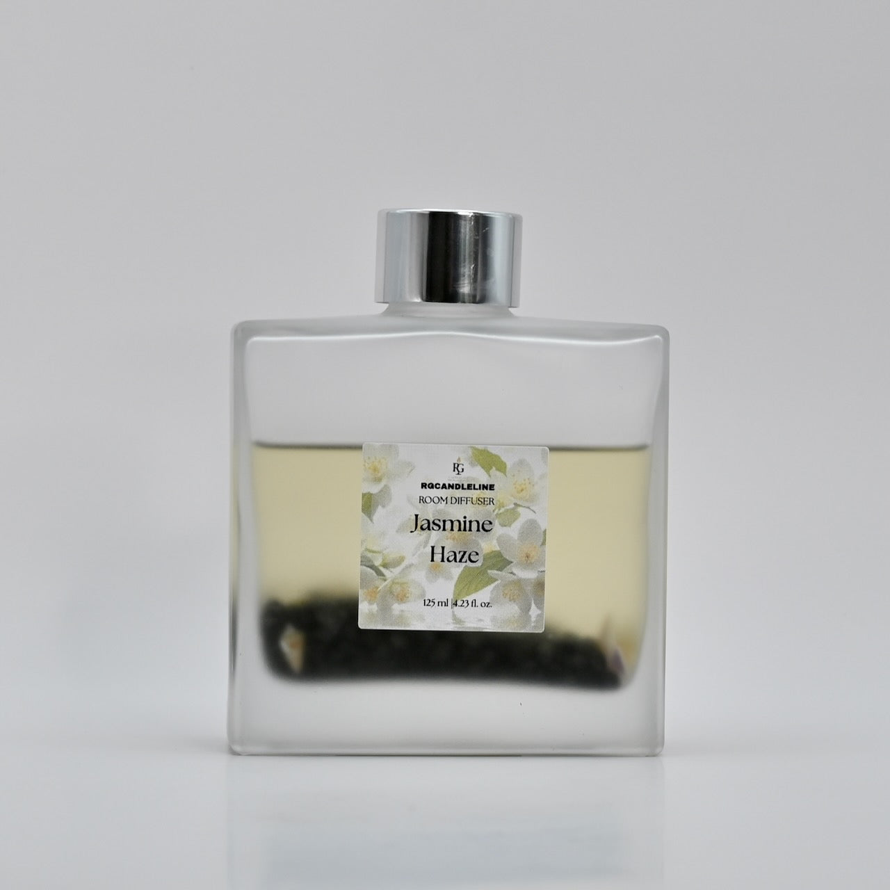 Perfume bottle labeled 'Jasmine Flare' on a light gray background