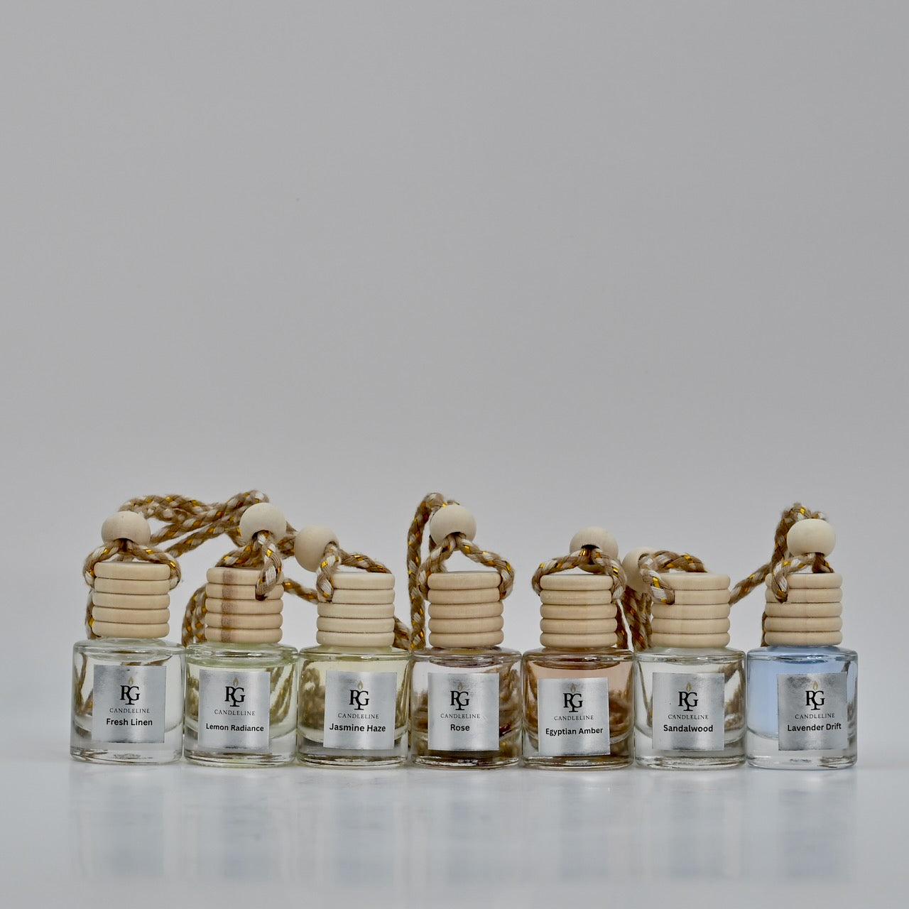 Set of six perfume bottles with wooden elements on a light gray background