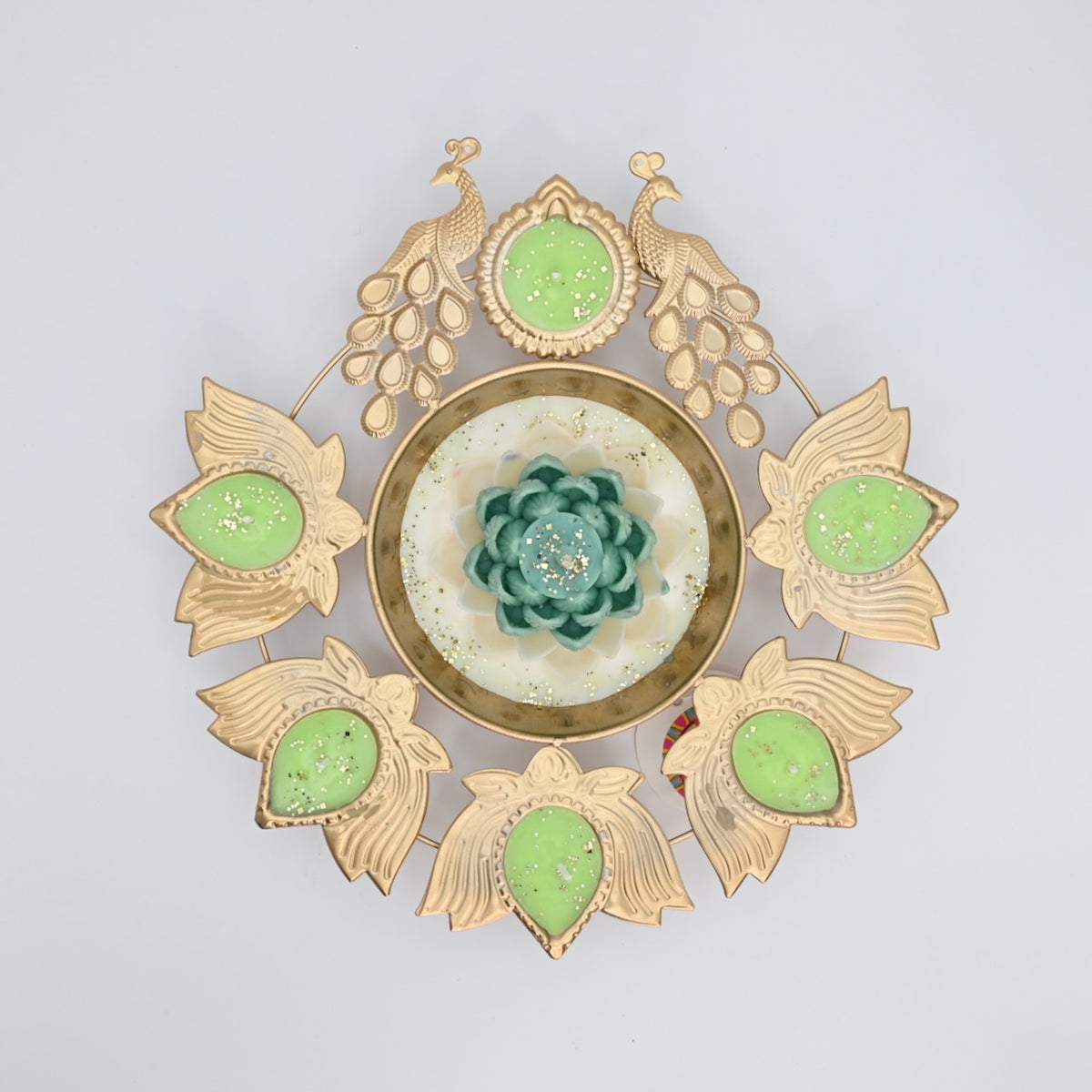 Top view of the Green Lotus Peacock Metal Urli Candle Arrangement with gold-toned peacocks, six leaf-shaped candle holders, and a green floral centerpiece.