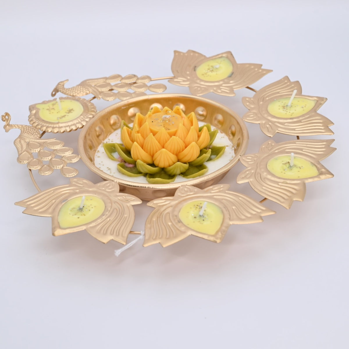 Left view of the Yellow Lotus Peacock Metal Urli Candle Arrangement with gold-toned peacocks and decorative candle holders.