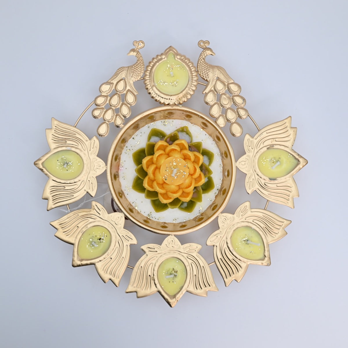 Top view of the Yellow Lotus Peacock Metal Urli Candle Arrangement with gold-toned peacocks, six leaf-shaped candle holders, and a yellow floral centerpiece.
