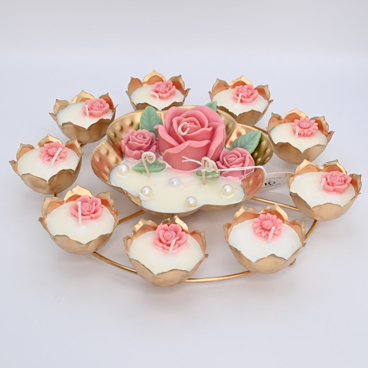 Top view of the Pink Rose Rose Garden Metal Urli Candle Arrangement with pink floral wax details, pearl accents, and a gold-toned lotus ring.