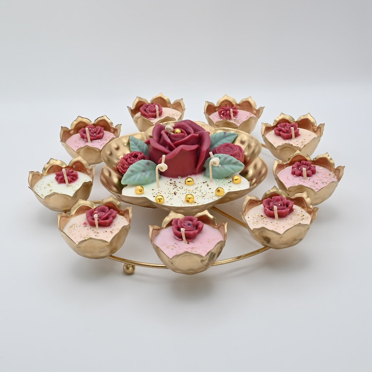Front view of the Red Rose Rose Garden Metal Urli Candle Arrangement with a raised red rose centerpiece and gold-toned candle cups.