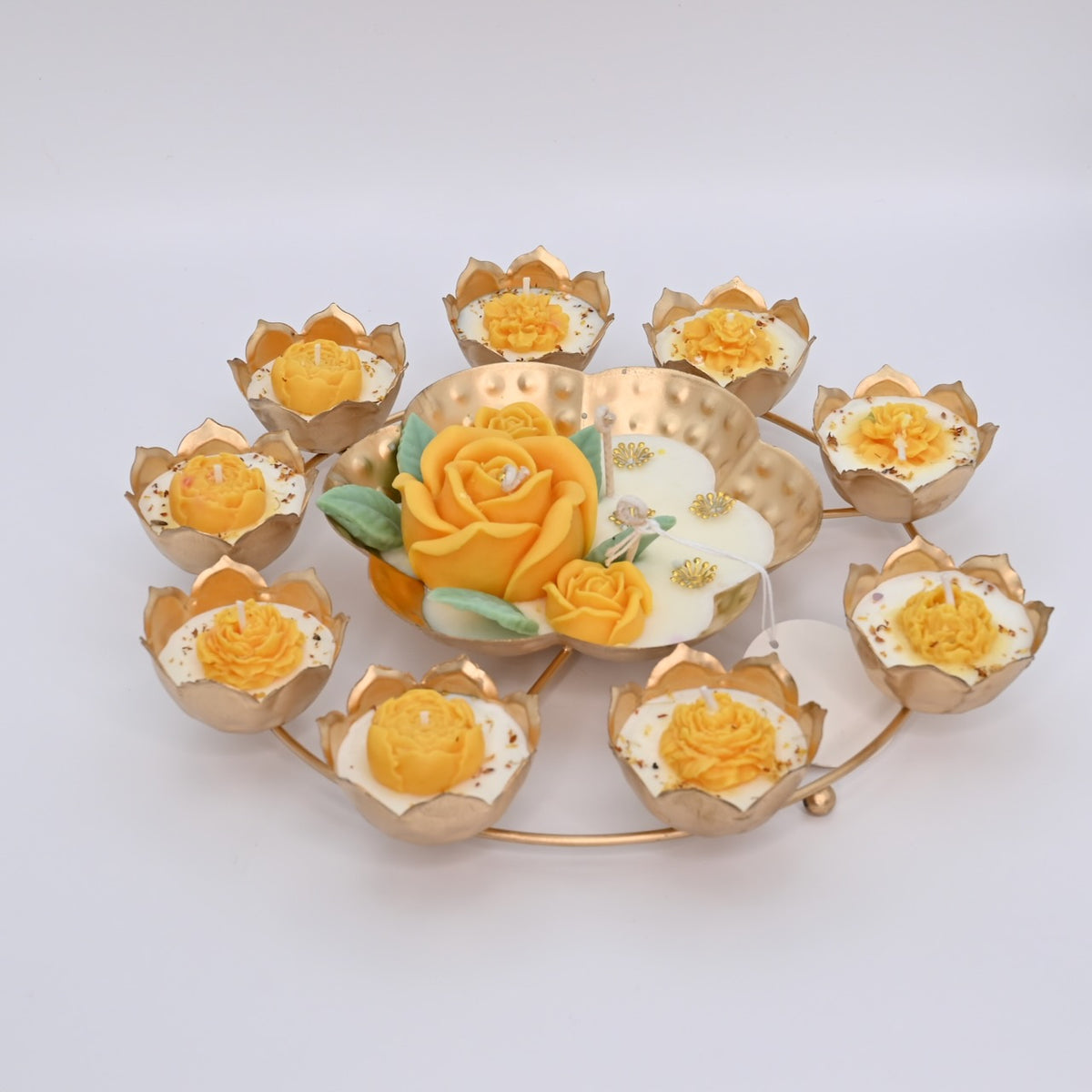 Left view of the Yellow Rose Rose Garden Metal Urli Candle Arrangement with a raised yellow rose centerpiece and lotus-shaped candle cups.