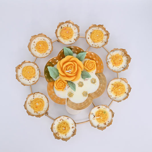 Top view of the Yellow Rose Rose Garden Metal Urli Candle Arrangement with yellow floral wax details, pearl accents, and a gold-toned lotus ring.