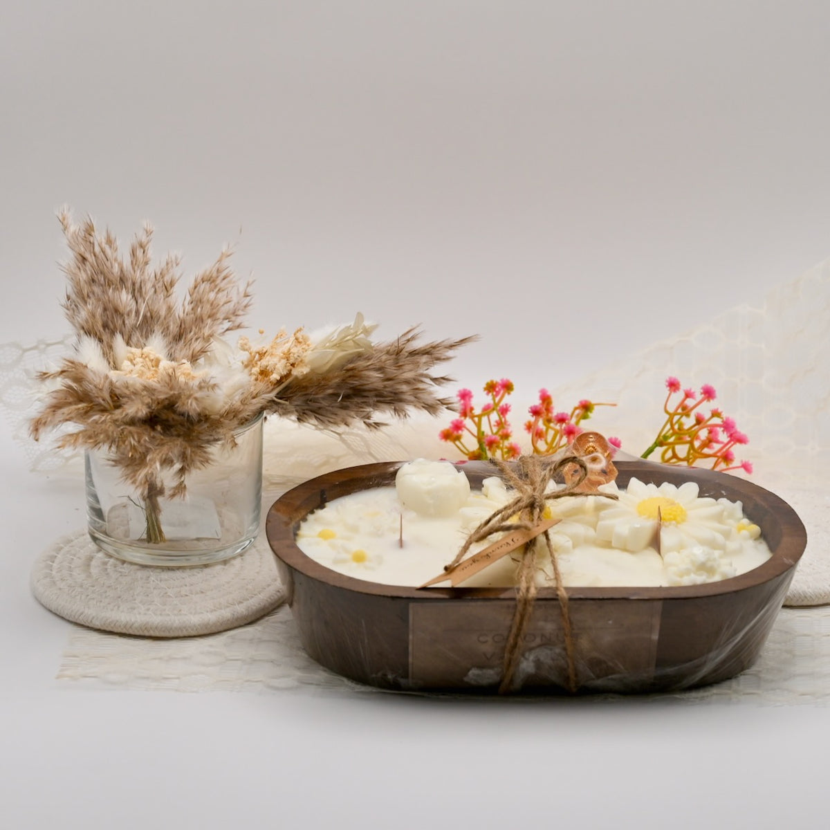 Close-up of a handcrafted wooden bowl candle with white soy wax daisies