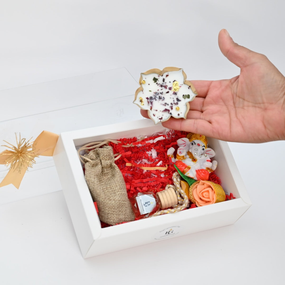Medium white gift box with candle displayed in hand
