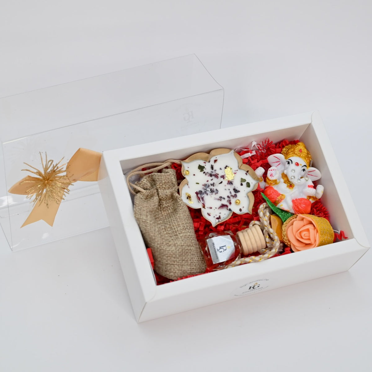 Medium white gift box with open lid and arranged gift hamper contents