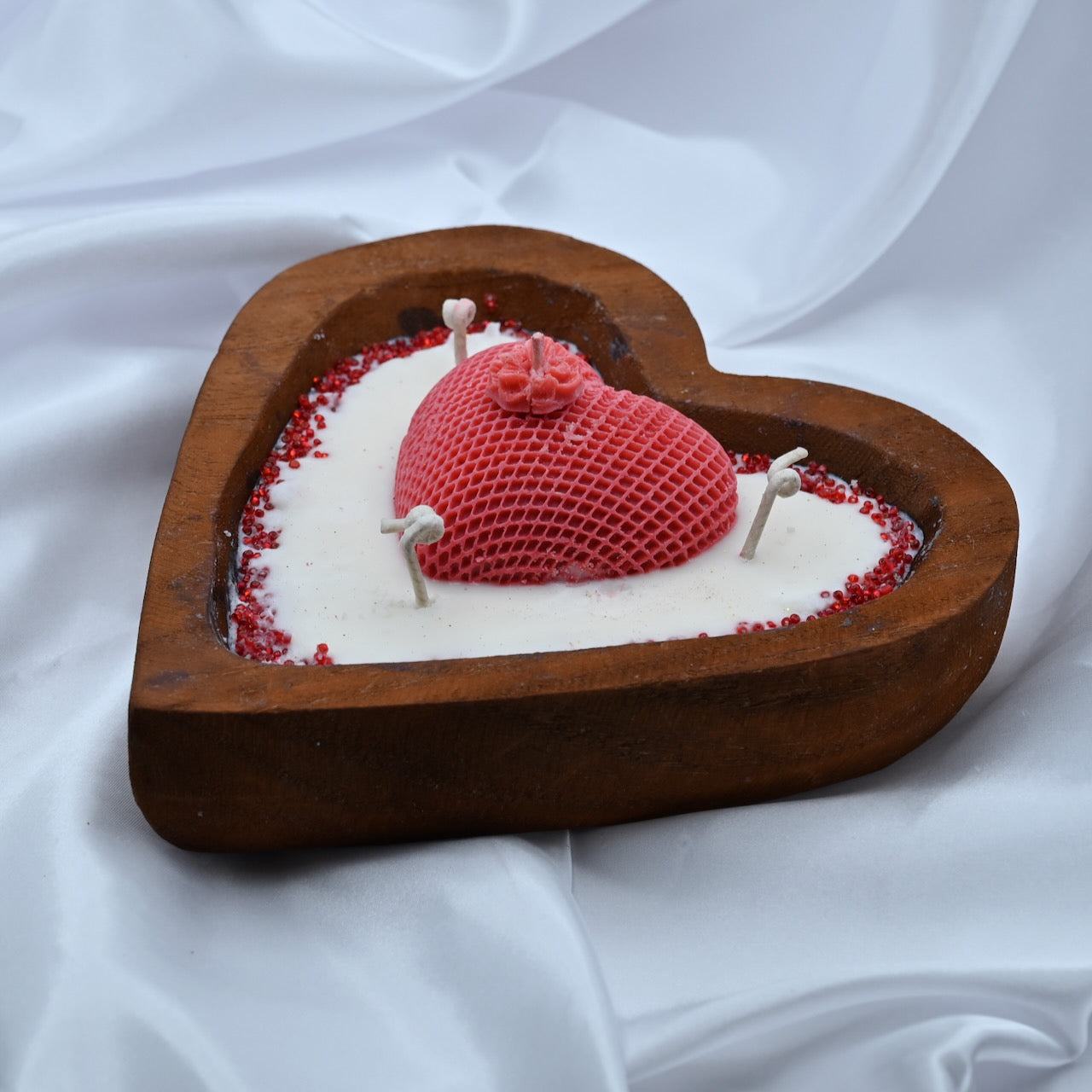 Left view of heart strings luxe red candle in a heart shaped wooden container