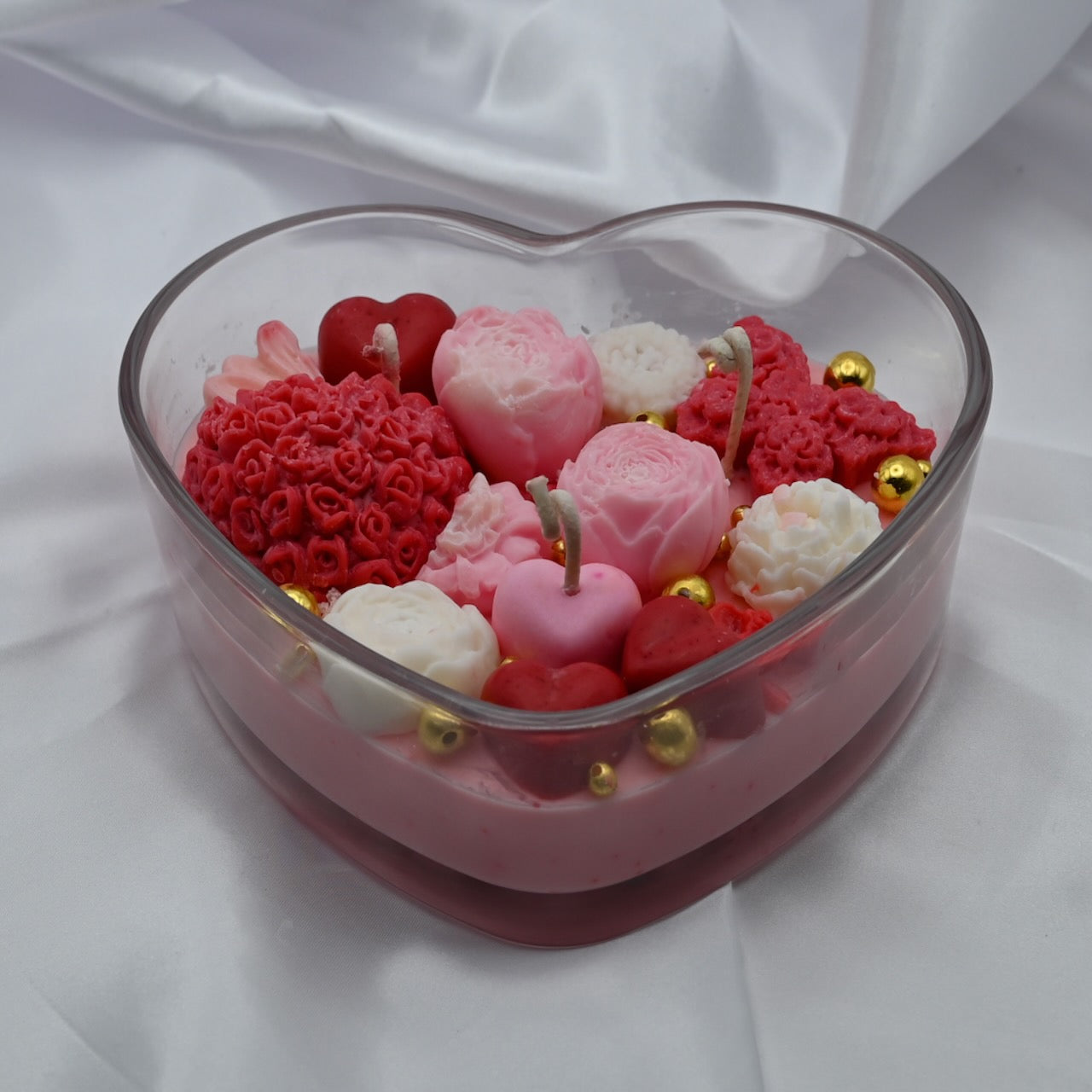 Hand-poured  rose soy candle in heart-shaped glass container from RG Candleline.